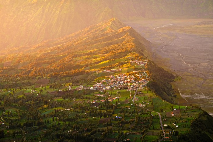 Gunung Bromo valley, East Java The valley opposite to Mount Bromo and Batok illuminated by morning rays at golden hour. Indonesia