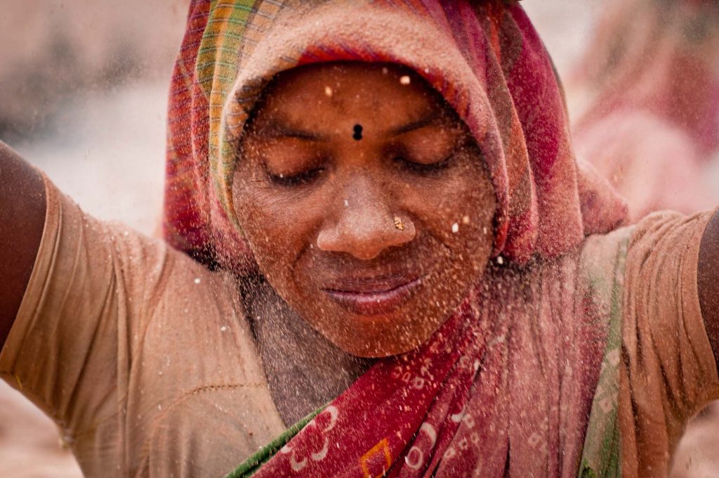 A lady working at a brick factory, inhaling the dusts without any protective gear