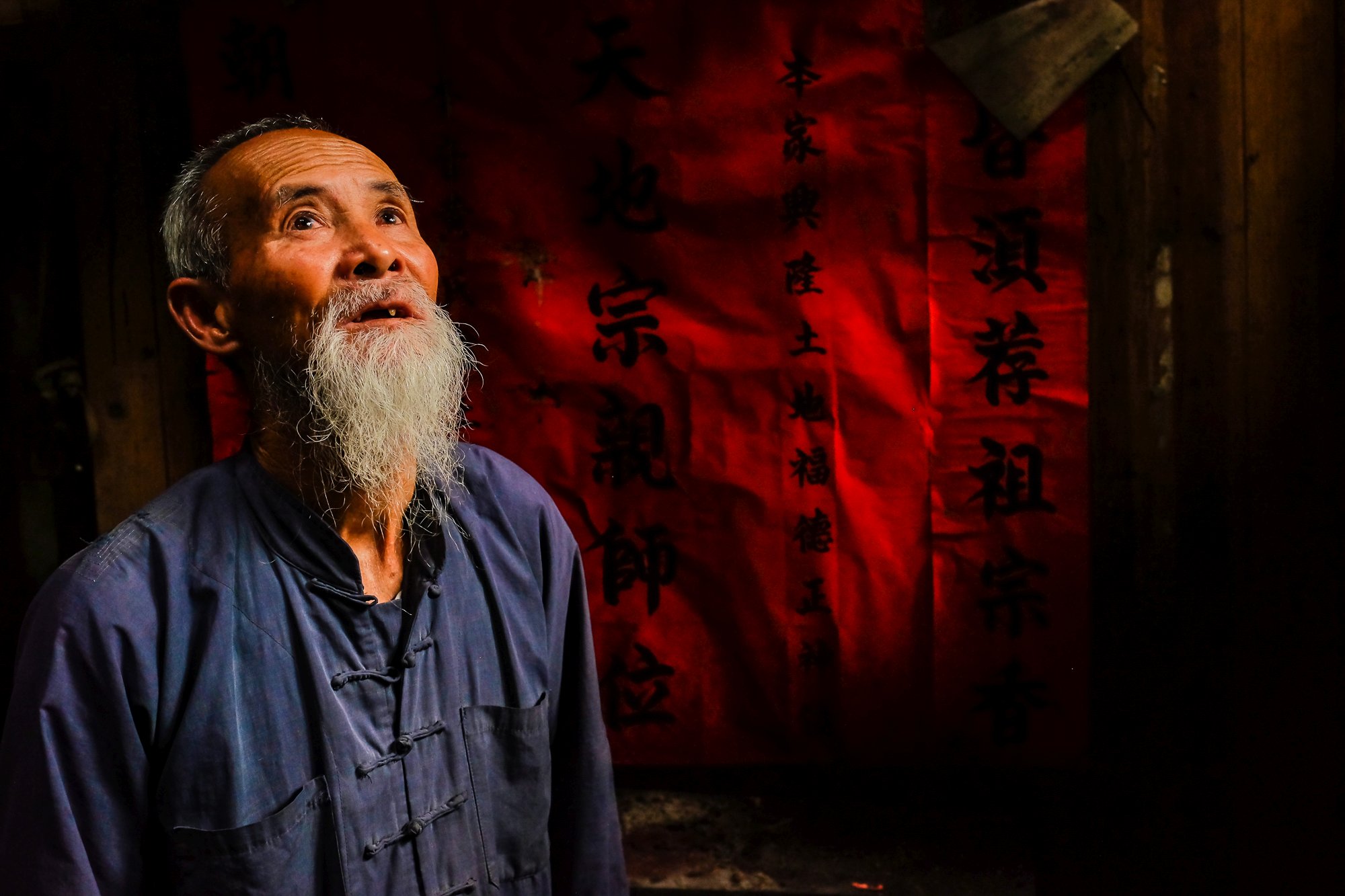 Huang Yue Ming - one of the oldest cormorant fishermen immersed in his deep thoughts as we speak with him at his house in Xingping village